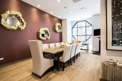 a dining room with a table and white chairs at Sq 1BR w Great views Indoor pool NYC-29 in New York