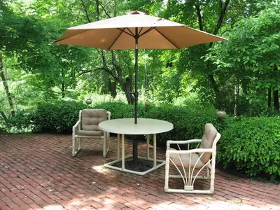 a table with two chairs and an umbrella at Private setting on country farm near Rhinebeck in Clinton Corners