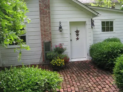a house with a white door and a brick driveway at Private setting on country farm near Rhinebeck in Clinton Corners