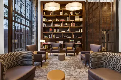 a waiting room with chairs and bookshelves at Tribeca Studio w Pool Roofdeck Gym View NYC-273 in New York