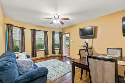 a living room with a blue couch and a tv at Bedroom near Yale Hospital/Bridgeport in Bridgeport
