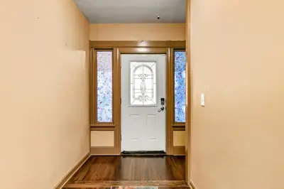 an empty hallway with a white door and windows at Bedroom near Yale Hospital/Bridgeport in Bridgeport