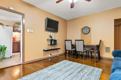 a living room with a dining room table and a tv at Bridgeport Bliss Solo Haven Near Yale & Downtown in Bridgeport