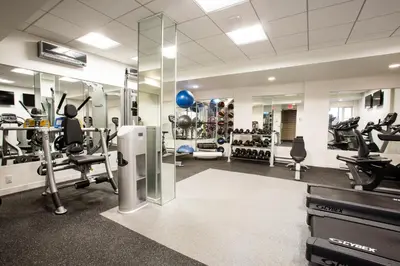 a gym with treadmills and machines in a room at Midtown E 1BR w Gym Doorman nr the 6 NYC-4 in New York
