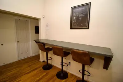 a counter in a room with two chairs at Tuk Ahoy - Emerald Suite 2C with Shared Spaces in Brooklyn