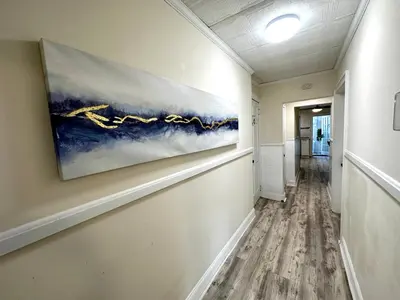 a hallway with a painting on the wall at 1-A Diamond in Yonkers, NY in Yonkers