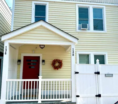 a house with a red door and a white fence at 4-A Diamond in Yonkers in Yonkers