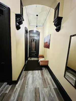 a hallway with a door and a couch at Spacious Apartment Downtown Albany, NY in Albany