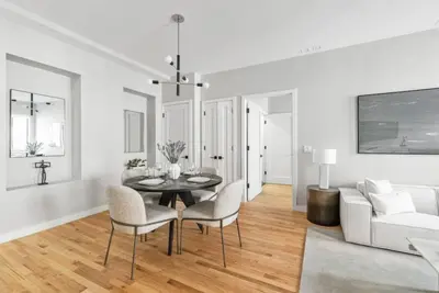 a living room with a table and chairs and a couch at Top Notch 2BR in Upper East Mins to Central Park in New York