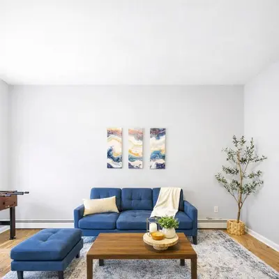 a living room with a blue couch and a table at Escape your everyday in your COZY HIDEAWAY Feel right at home Relax recharge & unwind in Troy