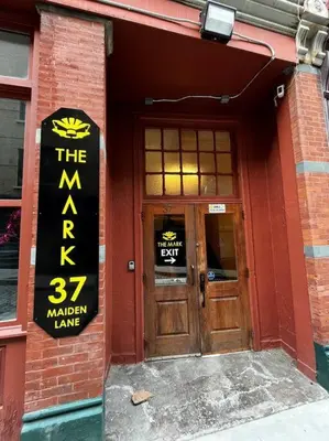a red brick building with a sign on the door at Downtown Albany 2 Bedroom + Workstation @ The Mark in Albany
