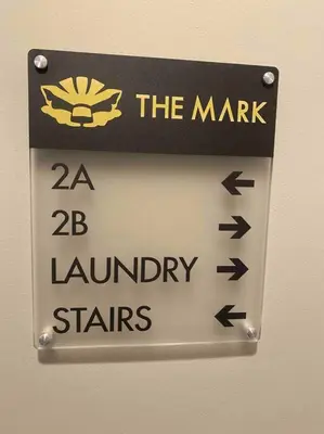a sign on a wall that reads the market and laundry stars at Downtown Albany 2 Bedroom + Workstation @ The Mark in Albany