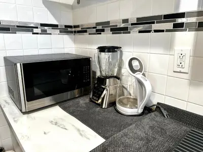 a kitchen counter with a microwave and a blender at 2-A Diamond in Yonkers in Yonkers