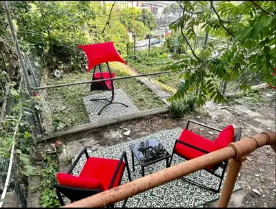 a group of red chairs sitting on a balcony at 2-A Diamond in Yonkers in Yonkers