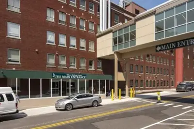 a car parked on a street in front of a building at Intimate 1 Bedroom Apt by UHS in Binghamton