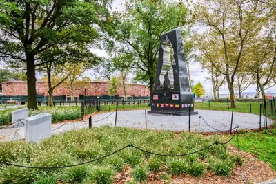 a sculpture in a park with trees and a fence at FiDi 1br w fitness center nr freedom tower NYC-1340 in New York