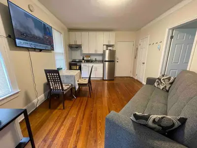 a living room with a couch and a kitchen at Entire Beautiful 2BR Apartment [L]. Convenient location in the heart of Queens! in Whitestone