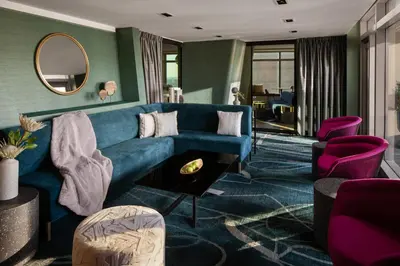 a living room with a blue couch and purple chairs at Financial District 1br w WD gym elevator NYC-1368 in New York
