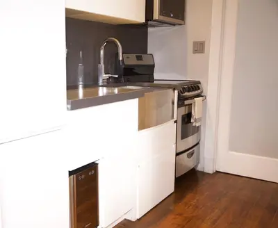 a kitchen with a sink and a stove at New York Style Stay near Central Park in New York