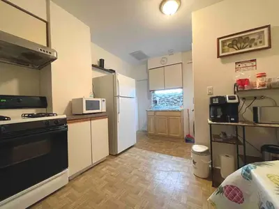 a small kitchen with a stove and a refrigerator at Entire Beautiful 1BR for You! [R] in Whitestone