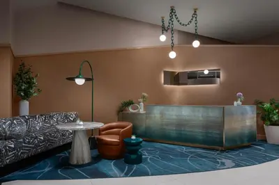 a waiting room with a table and a chair at Financial District 1br w WD gym elevator NYC-1376 in New York