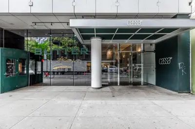 a glass entrance to a building with a pole at Midtown West 1br w doorman nr rockefeller center NYC-1394 in New York