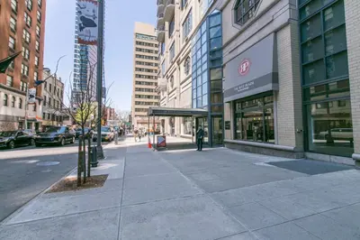 a city street with buildings and a person walking on the sidewalk at Midtown 1br w gym elevator nr Rockefeller Ctr NYC-1401 in New York