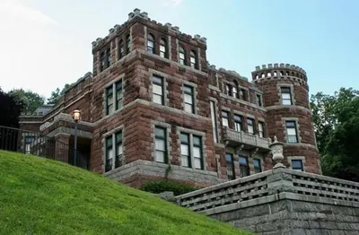 a large brick building on top of a hill at Bright, Stylish & Cozy 2Bed Unit w/Backyard & Grill Close to NYC! in Haledon