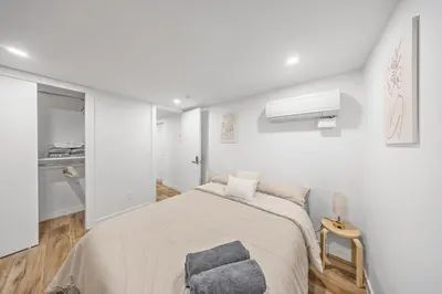 a white bedroom with a bed and a window at Private Room with Shared Bathroom at an Apartment by Times Square in New York