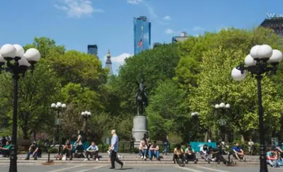 a group of people sitting on benches in a park at Oasis Retreat - Cozy studio in Union Square in New York