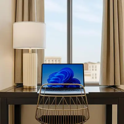 a laptop computer sitting on a desk next to a window at Downtown Hartford Condo - Bushnell Park - Convention Center in Hartford