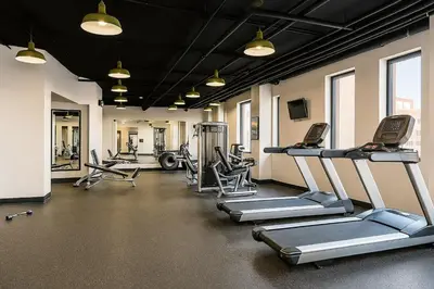 a gym with several treadmills and machines in it at Downtown Hartford Condo - Bushnell Park - Convention Center in Hartford
