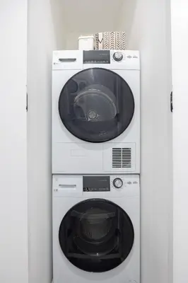 a washing machine and a dryer in a room at SWJ544 - Chic 1BR in the Heart of NYC in New York