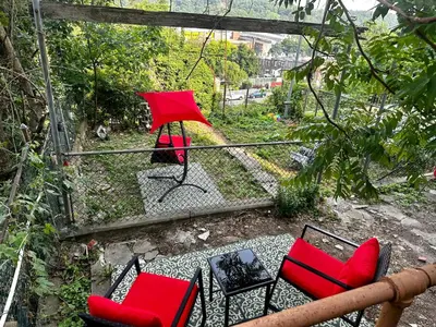 a group of chairs and tables and an umbrella at 9-A Diamond in Yonkers, NY in Yonkers