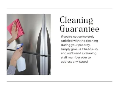 a woman is cleaning a refrigerator with a towel at Downtown Hartford Condo - Ciy Center - Prime Location in Hartford