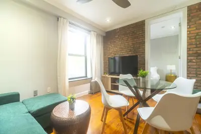 a living room with a couch and a table at New York Suite Upper East Side Manhattan in New York