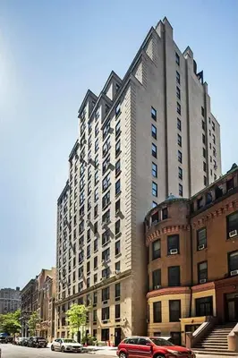 a tall building with a red car parked in front of it at 73-304 Newly Reno Studio UWS Doorman Gym Laundry in New York