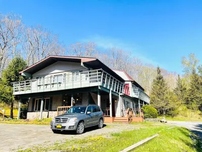 a house with a car parked in front of it at Catskill Cabin The Flamingo Suite 5 in Shandaken