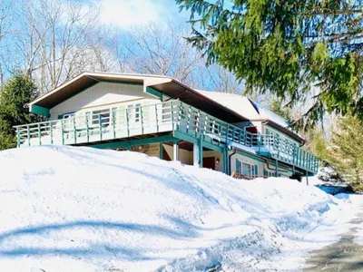 a house on top of a pile of snow at Catskill Cabin Zen Mantra Apt in Shandaken
