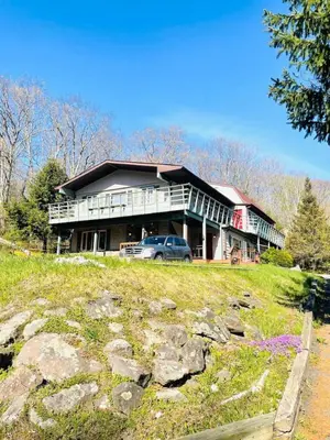 a large house with a car parked in front of it at Catskill Cabin Zen Mantra Apt in Shandaken