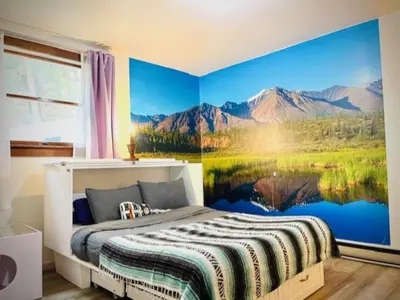 a bedroom with a mountain mural on the wall at Alpine Four Season Lodge Shandaken NY sleeps 18 in Shandaken