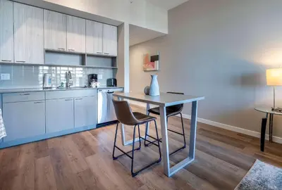 a kitchen with a table and chairs in a room at Trendy Apt On Harbor with Gym in Stamford