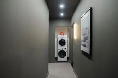 a hallway with a washer and dryer in a room at Luxe Studio with Charming Juliet Balcony in New York