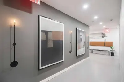 a hallway with two framed pictures on a wall at Studio w Charming Juliet Balcony in Upper East in New York