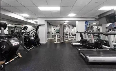 a gym with lots of treadmills and machines at 73-308 New 1BR 1Bth UWS Doorman Gym in New York