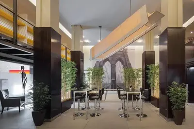 a lobby with tables and chairs and a building at 73-518 Newly Reno Studio UWS Doorman Gym Laundry in New York