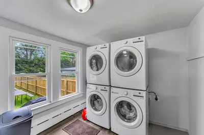 a laundry room with two washers and a window at Pitcher's Paradise Apt 2-All Star Baseball Rentals in Oneonta