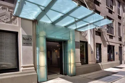 a glass entrance to a building on a city street at 73-1406 New 1BR 1Bth UWS Doorman Gym in New York