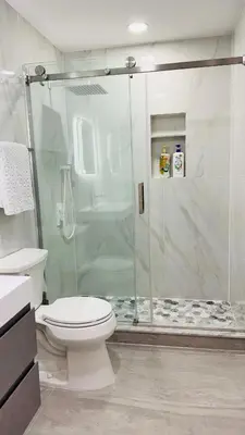 a bathroom with a toilet and a glass shower at Fancy private home