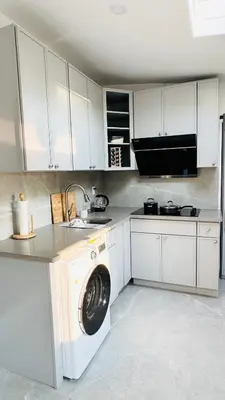 a white kitchen with a washing machine in it at Fancy private home